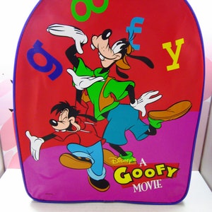May include: A red, blue, and purple backpack with a cartoon image of Goofy and a smaller Goofy character. The backpack has the text "Disney's A Goofy Movie" on the front.