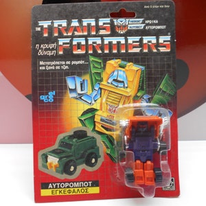 TRANSFORMERS G1 HUFFER Errore di scheda Autobot Action Figure 1985 Greco El Greco Hasbro Sigillato Originale Vintage Raro