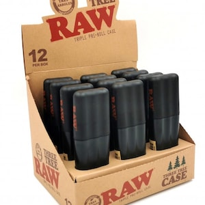 May include: A display box containing 12 black RAW Three Tree Pre-Roll Cases. The box is brown with the RAW logo and text that says "Three Tree Case".