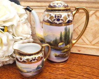 Antique Noritake Porcelain Tranquil Lake & Mountain Scene Coffee Pot and Creamer, Hand painted Cobalt Gold c1930s