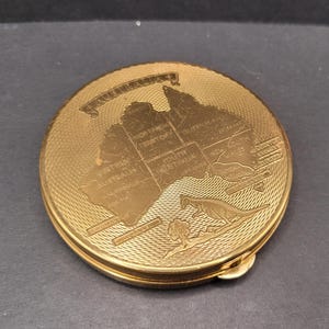 Carte vintage en poudre compacte représentant un Australien et un kangourou, ton moteur tourné vers l'or