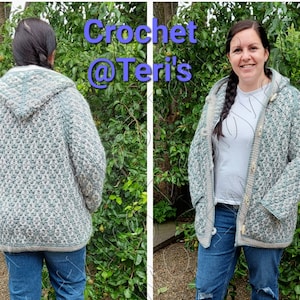 May include: A hooded crocheted cardigan in green and white with a button closure. The cardigan is shown on a person wearing blue jeans.
