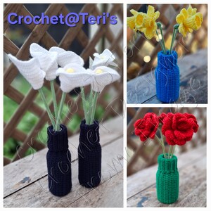 May include: Crocheted flowers in vases. The image shows white calla lilies, yellow daffodils, and red roses, each in a different colored vase. The vases are blue, green, and navy. The text "Crochet@Teri's" is at the top of the image.