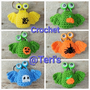 May include: Five crocheted bat keychains with googly eyes. Each bat has a different Halloween theme: spider web, pumpkin, ghost, spider, and orange.