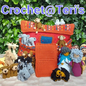 May include: A crocheted ark with a red roof and a blue window. The ark is filled with crocheted animals, including a lion, giraffe, elephant, monkey, and zebra. The ark is sitting on a wooden surface with green foliage in the background. The text "Crochet@Teri's" is displayed above the ark.