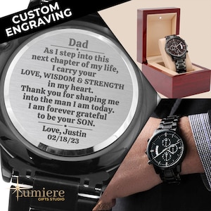 May include: Black wristwatch with a silver engraved message on the back. The message reads: "Dad, As I step into this next chapter of my life, I carry your LOVE, WISDOM & STRENGTH in my heart. Thank you for shaping me into the man I am today. I am forever grateful to be your SON. Love, Justin 02/18/23"