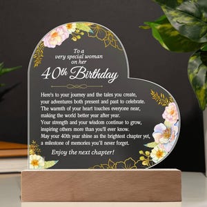 May include: A rustic wooden sign with the text "Welcome to our home" in white lettering. The sign has a distressed finish and a simple, inviting design, ideal for front door decor.