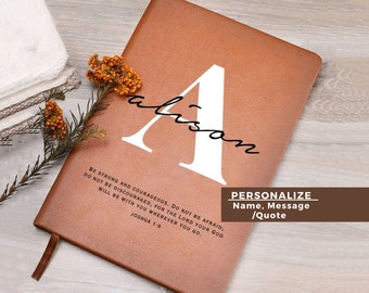 May include: A brown leather journal with the name "Alison" written in white cursive on the front. The journal has a quote from Joshua 1:9 printed on the front: "Be strong and courageous. Do not be afraid; do not be discouraged, for the Lord your God will be with you wherever you go."