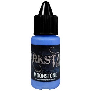 May include: A small, blue bottle of Moonstone paint with a black cap and dropper. The label features the text "DARKSTAR" in a stylized font, with "MOONSTONE" below. The website address is visible at the bottom of the label.