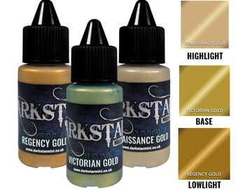 May include: Three small paint bottles with black caps and labels, showcasing gold tones. The labels read "Regency Gold," "Victorian Gold," and "Renaissance Gold." Color swatches for highlight, base, and lowlight are also shown.