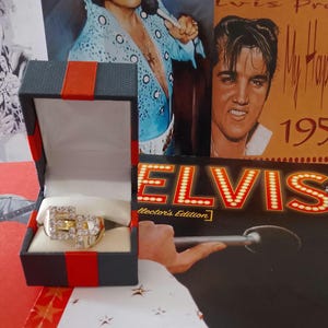 May include: A trio of ceramic mugs with a speckled, matte finish in cream, light grey, and dark grey. Each mug features a simple, minimalist design, ideal for tea or coffee.