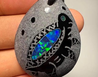Beautiful black obsidian pendant with opal inlay, including the center hole and pendant. Measurements 40.18x31.71x9.50mm