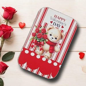 May include: A Valentine's Day themed tin with a teddy bear holding roses. The tin has a red and white striped background with the words "HAPPY Valentine's DAY". Red roses and heart-shaped decorations are also present.