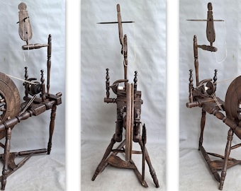May include: A wooden spinning wheel with a large, spoked wheel and intricate wooden frame. The wheel is dark brown and appears to be antique. The design includes a flyer, spindle, and other components for spinning yarn. The wheel is set against a neutral background.