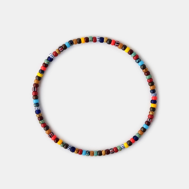Men colorful bracelet made with 3mm multicolor glass beads that are strung on an elastic cord that easily slips on your wrist for easy eveyday wear with your any casual look.