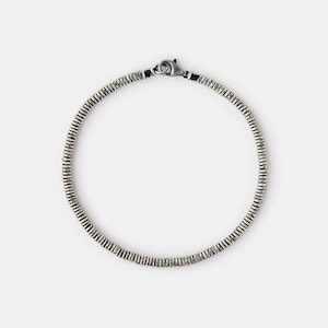 May include: A silver bracelet with a clasp closure. The bracelet is made of small, round beads.
