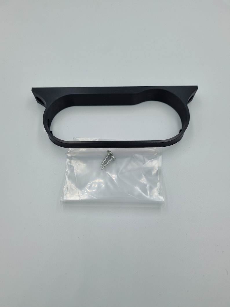 May include: Black plastic gauge pod mount with a single screw included in a clear plastic bag.