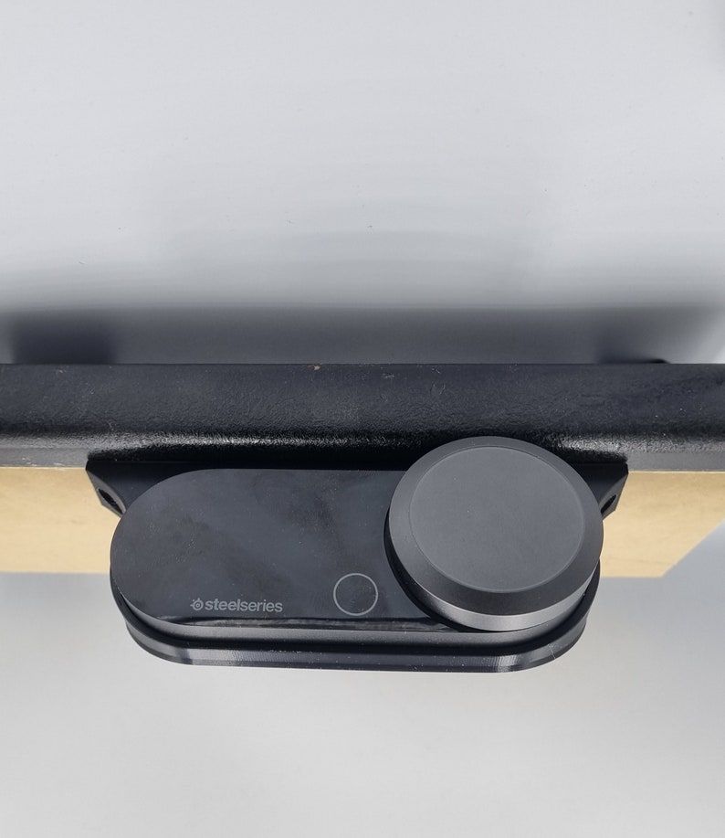 May include: A black SteelSeries gaming headset with a round, black volume control knob.