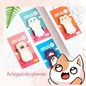Puede incluir: Cuatro blocs de notas adhesivas de colores con ilustraciones de gatos. Cada bloc tiene el texto "HOHO CAT STICKY MEMO 30P" impreso en él. Los gatos están en varias poses y colores, incluyendo blanco, marrón, negro y gris.