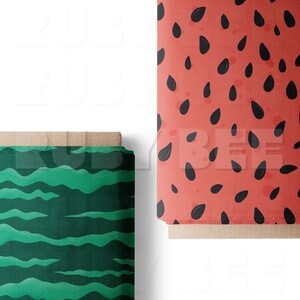 May include: Two rolls of fabric with different patterns. One roll has a green and white striped pattern, the other has a red background with black watermelon seeds.