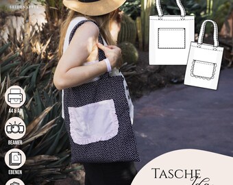 Peut inclure: Un sac fourre-tout à pois bleu marine avec une poche rose clair à bordure volantée. Le sac est porté par une personne portant un chapeau de paille. L'image montre également un schéma du design du sac. Le texte sur l'image dit "TASCHE Ida".