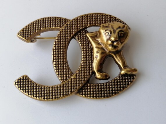 Chanel lion brooch discount