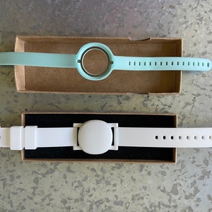 This product is the white plastic adapter and the optional watch band shown in the lower portion of the photo. The product replaces the original blue band (top).