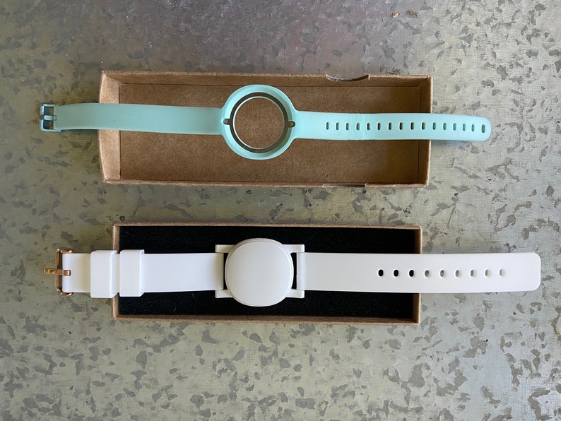 This product is the white plastic adapter and the optional watch band shown in the lower portion of the photo. The product replaces the original blue band (top).