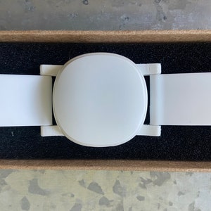 Close-up of the top side of the adapter. The optional watch band is shown attached to the lugs of the adapter, and an Ava Fertility Tracker 2.0 is attached (fertility tracker not included in this listing).