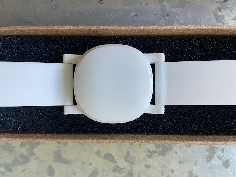 Close-up of the top side of the adapter. The optional watch band is shown attached to the lugs of the adapter, and an Ava Fertility Tracker 2.0 is attached (fertility tracker not included in this listing).