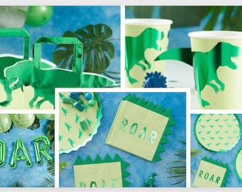 May include: Green and yellow dinosaur-themed party supplies, including plates, cups, napkins, and favour bags. The supplies feature a green dinosaur silhouette with the word "ROAR" printed on them.