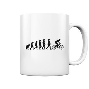 Può includere: Tazza in ceramica bianca con una silhouette nera dell'evoluzione dell'uomo, che termina con una persona in bicicletta.
