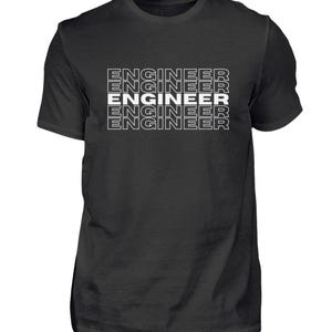 May include: Black crew neck t-shirt with the word "ENGINEER" printed in white, stacked five times vertically. The text has a simple, clean font. The shirt is a solid color and appears to be made of cotton.