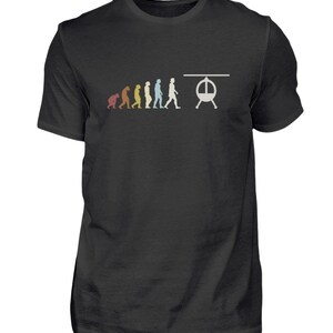 Może przedstawiać: Czarny T-shirt z grafiką przedstawiającą linię ludzkich postaci, symbolizujących ewolucję człowieka, kończącą się helikopterem. Postacie są w różnych kolorach, w tym czerwonym, pomarańczowym, żółtym, zielonym, niebieskim i fioletowym.