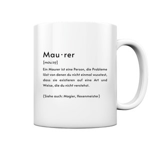 Könnte beinhalten: Weiße Keramiktasse mit schwarzem Text, der "Maurer [mau:eg] Ein Maurer ist eine Person, die Probleme löst von denen du nicht einmal wusstest, dass sie existieren auf eine Art und Weise, die du nicht verstehst. (Siehe auch: Magier, Hexenmeister)" lautet.