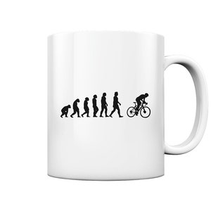 Può includere: Tazza in ceramica bianca con una silhouette nera dell'evoluzione dell'uomo, che termina con un ciclista in bicicletta.