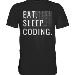May include: Black t-shirt with the white text "EAT. SLEEP. CODING." The word "CODING" is in a white rectangle with a binary code pattern. The shirt is a crew neck style.