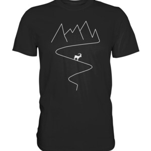 May include: Black t-shirt with a white graphic design of a mountain range and a goat walking on a winding path.