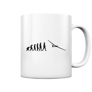 Könnte beinhalten: Weiße Keramiktasse mit einer schwarzen Silhouette der Evolution des Menschen, die mit einem Segelflieger endet. Der Text "Evolution of a Glider Pilot" ist auf die Tasse gedruckt.