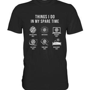 May include: A black t-shirt with white text that reads "Things I do in my spare time". The text is surrounded by six icons depicting bees and bee-related activities, including hanging out with bees, watching bees, researching bees, talking about bees, thinking about bees, and dreaming about bees.