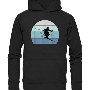 Könnte beinhalten: Schwarzer Hoodie mit einem Retro-Grafikdruck eines Skifahrers in Silhouette vor einem blauen und weißen Sonnenuntergang.