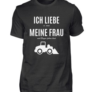 May include: Black t-shirt with white text that reads "Ich liebe es, wenn meine Frau mich Bagger fahren lässt" and a white silhouette of a small excavator.