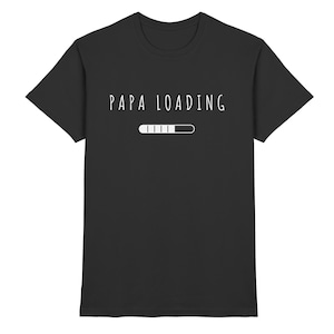 Peut inclure: T-shirt noir avec le texte "Papa Loading" et un graphique de barre de progression.