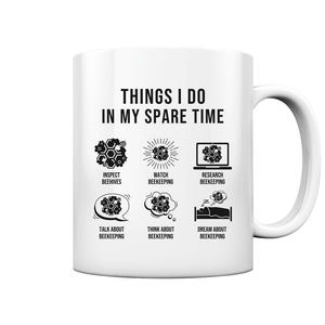 May include: White ceramic mug with a black design that says "Things I do in my spare time" and lists activities related to beekeeping, including inspecting beehives, watching beekeeping, researching beekeeping, talking about beekeeping, thinking about beekeeping, and dreaming about beekeeping.