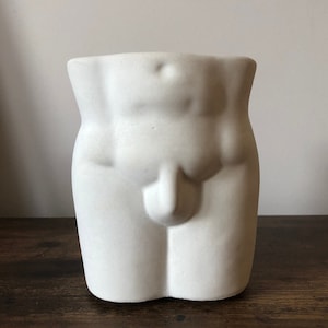 concrete male torso pot