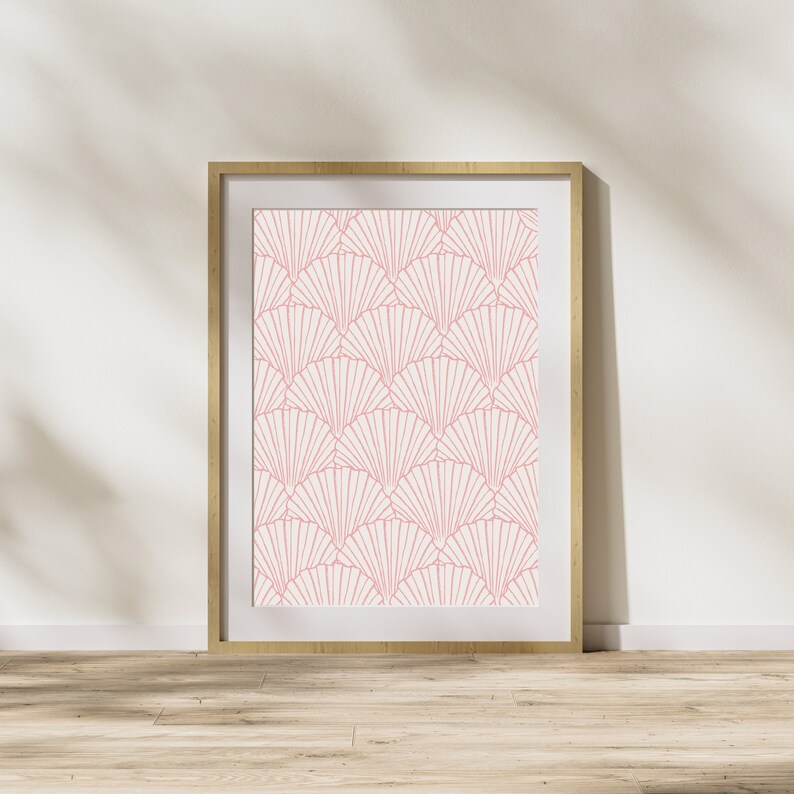 May include: A framed print with a geometric pattern of pink fan shapes on a white background. The frame is made of light wood.