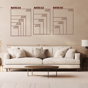 May include: A white sofa with three pillows sits in front of a beige wall with a diagram showing different ratios for wall art. The diagram shows the ratios 3:4, 2:3, and 4:5 with measurements in inches and centimeters. The text "THE SHELL SHOP" is at the top of the wall.