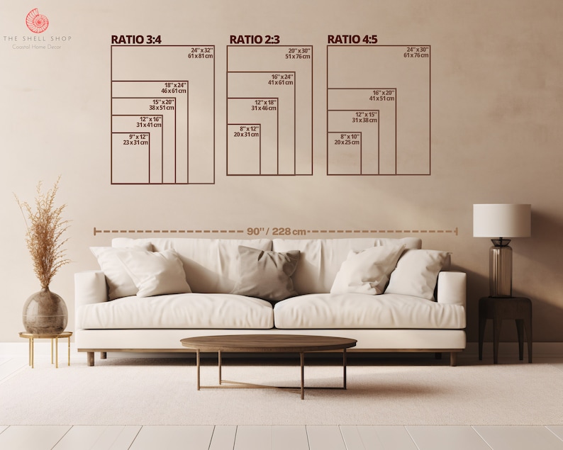 May include: A white sofa with three pillows sits in front of a beige wall with a diagram showing different ratios for wall art. The diagram shows the ratios 3:4, 2:3, and 4:5 with measurements in inches and centimeters. The text "THE SHELL SHOP" is at the top of the wall.