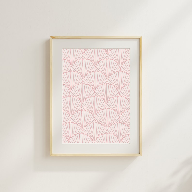 May include: A framed print with a pink and white geometric pattern of overlapping fans. The print is in a light wood frame.