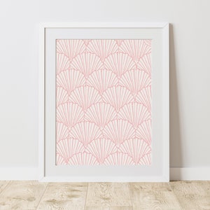 May include: A white frame with a pink and white geometric pattern print. The pattern is made up of overlapping fan shapes.